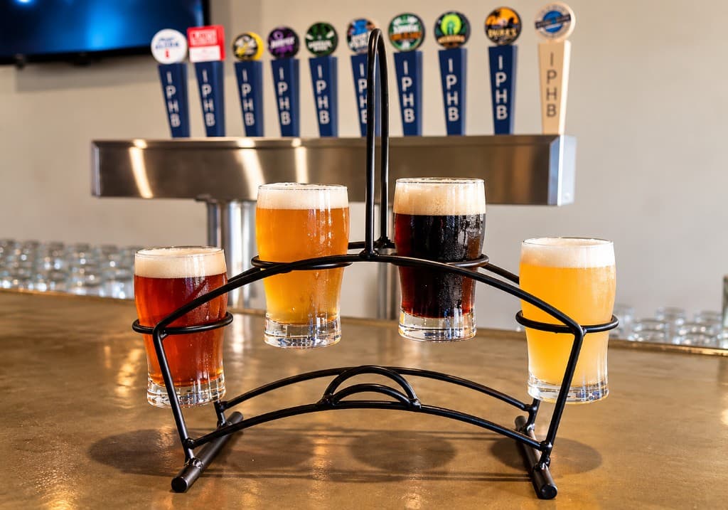 A four-glass beer flight on the bar at Interruption Public House